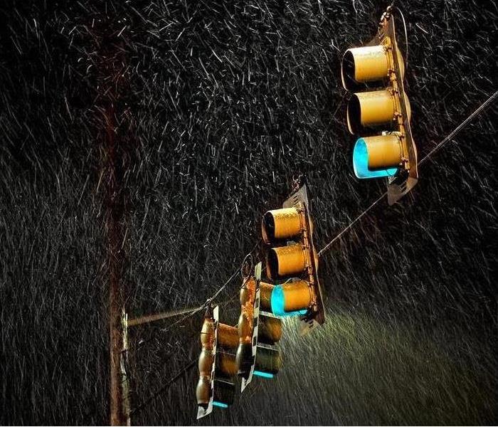 four streetlights swinging in the stormy rain at night